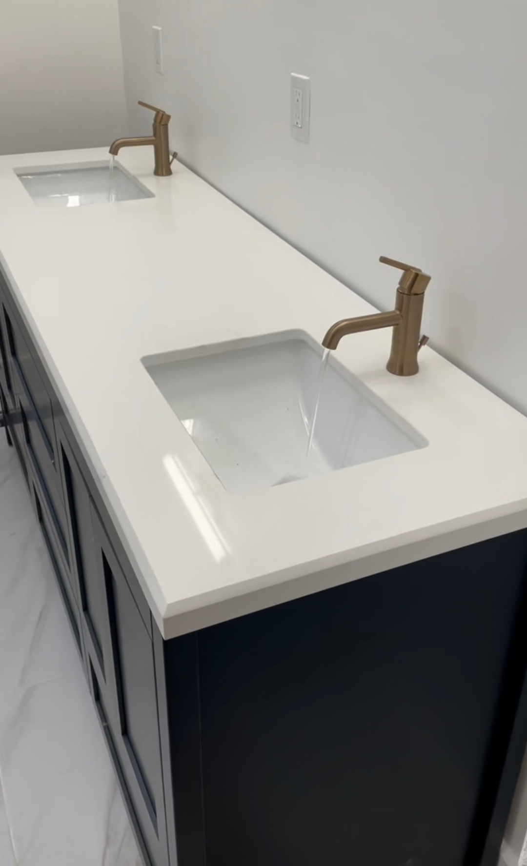 Double undermount vanity sink installation on quartz countertop