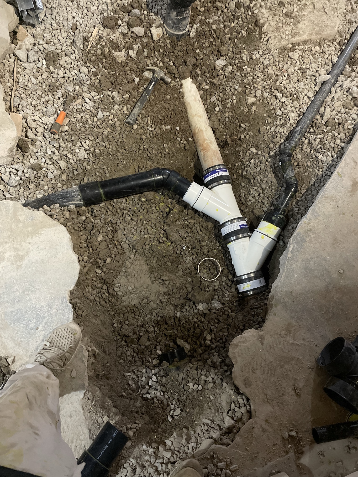 Underground drain and water separation rough-in dug into concrete basement floor